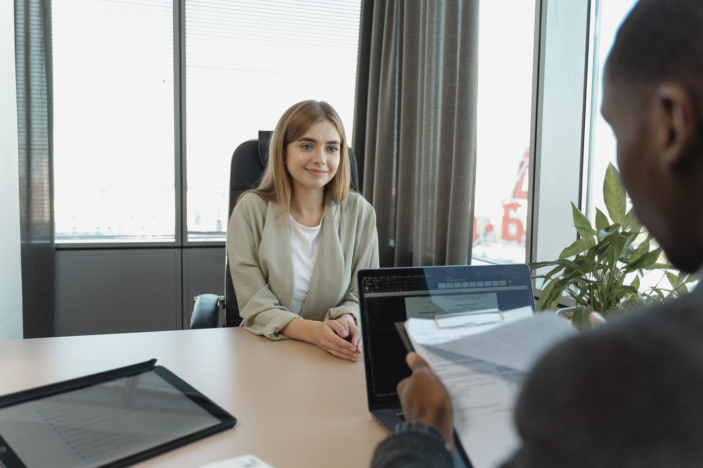 Teacher candidate smiling confidently during a job interview with school administrator